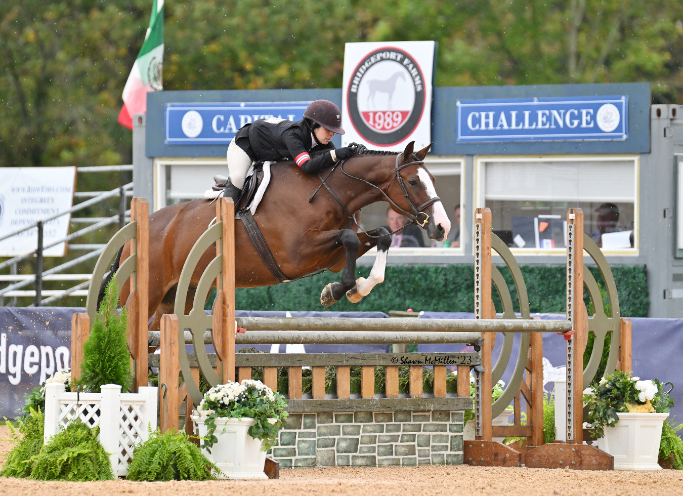 Rider Abby Felsenthal and horse Imperium clear a jump in an outdoor arena